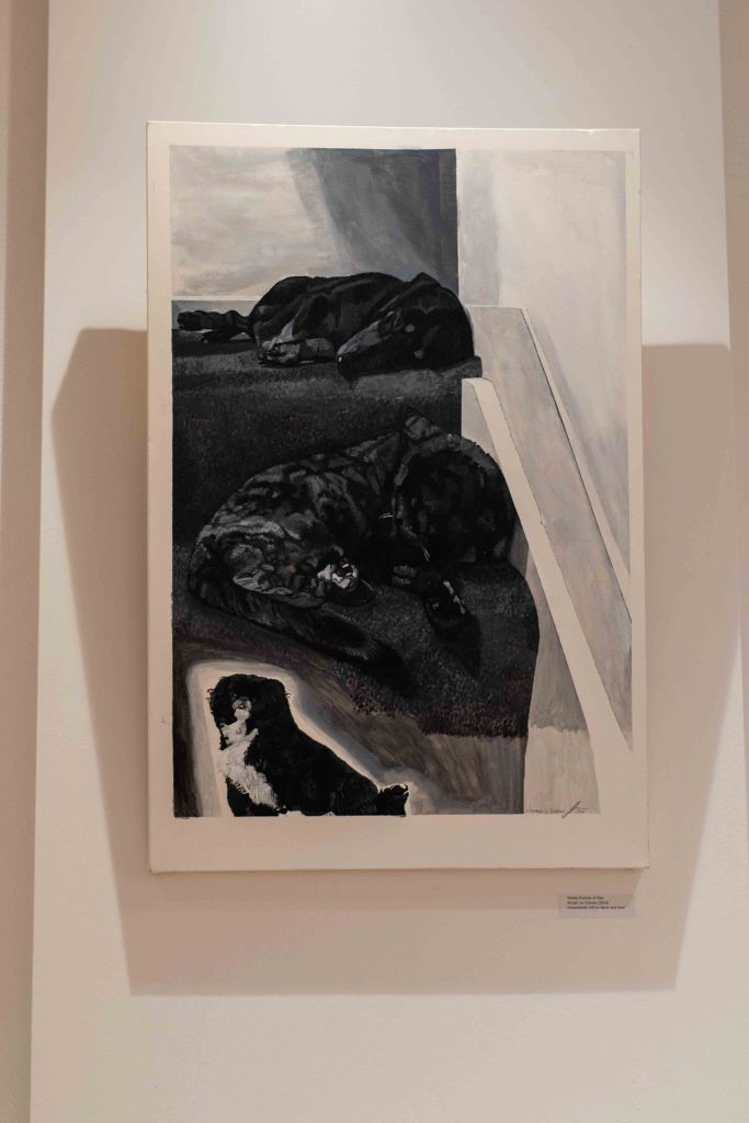 A black and white painting depicting several dogs lying on a surface, with a smaller dog in the foreground.