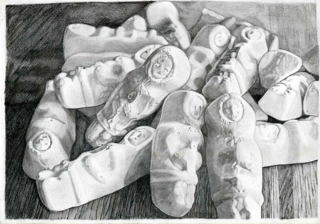 A detailed pencil drawing of New Zealand lollies, depicting various shapes and designs stacked on a wooden surface.